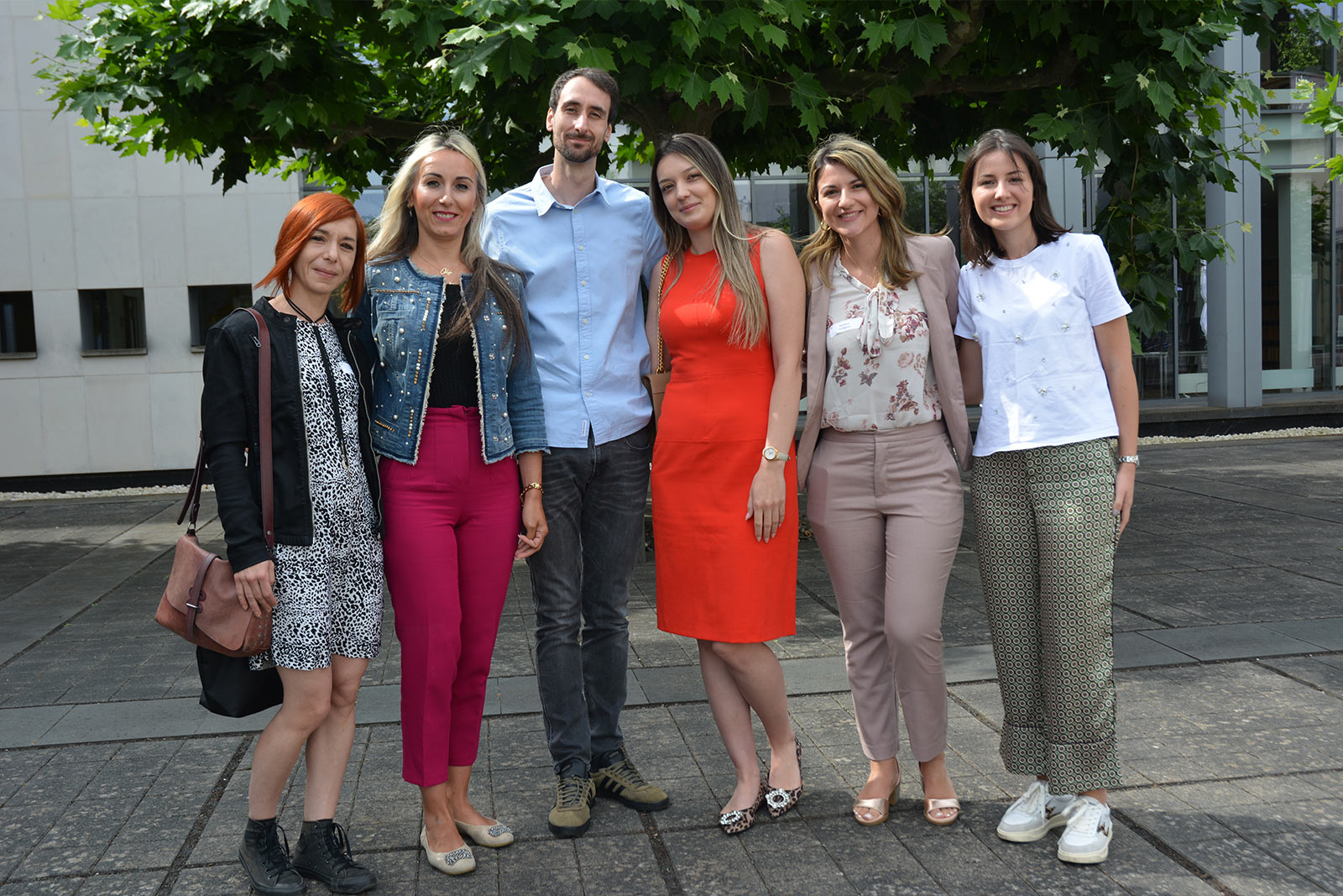 Group photo of Friends of ERA Scholarship Programme participants standing outdoors, representing young legal professionals and international exchange in European law.