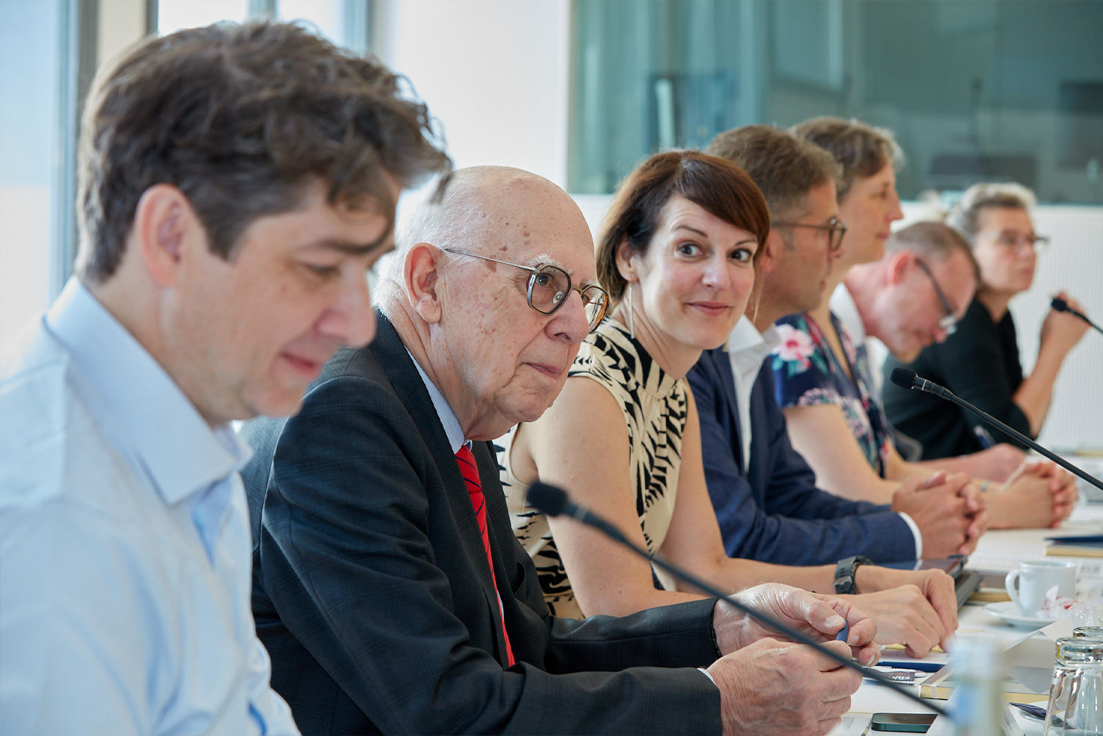 Friends of ERA members sitting at a conference table during a meeting, symbolizing dialogue, collaboration, and engagement in European law.