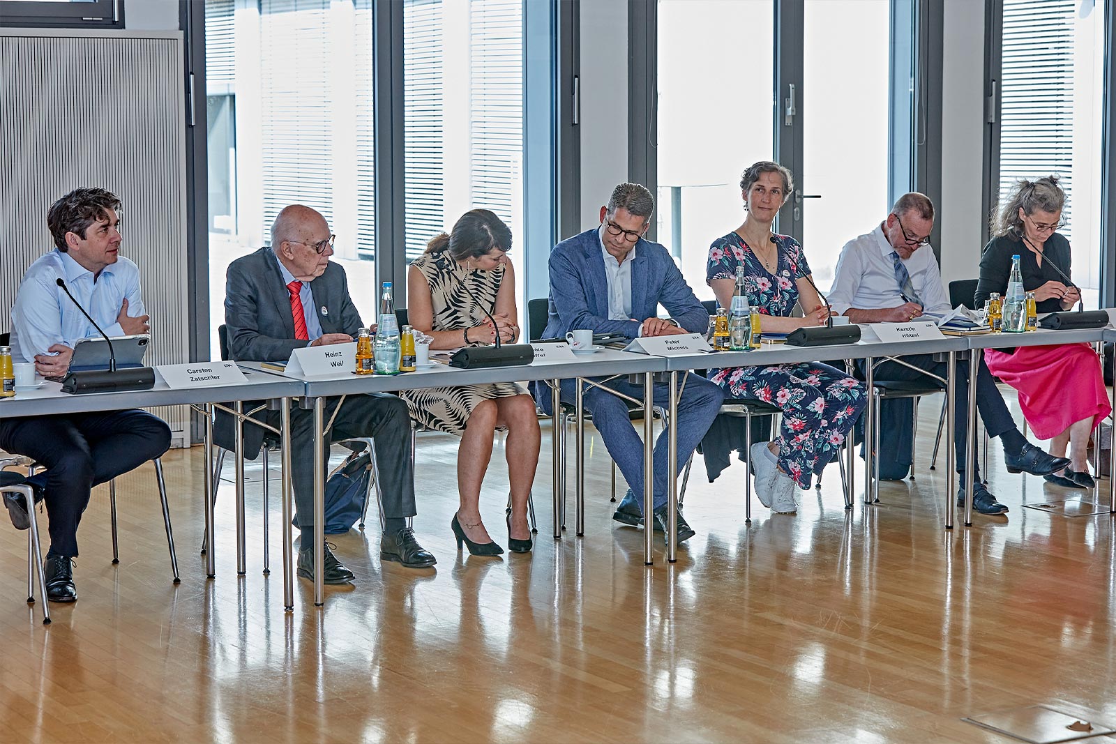 Friends of ERA members sitting at a conference table during a meeting, symbolizing dialogue, collaboration, and engagement in European law.