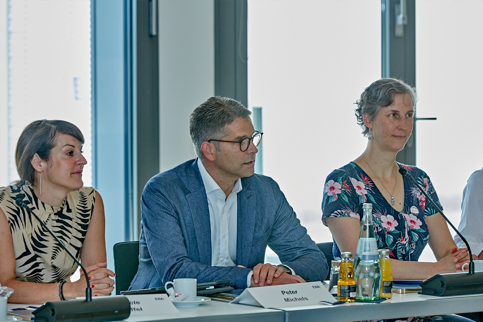 Friends of ERA members sitting at a conference table during a meeting, symbolizing dialogue, collaboration, and engagement in European law.