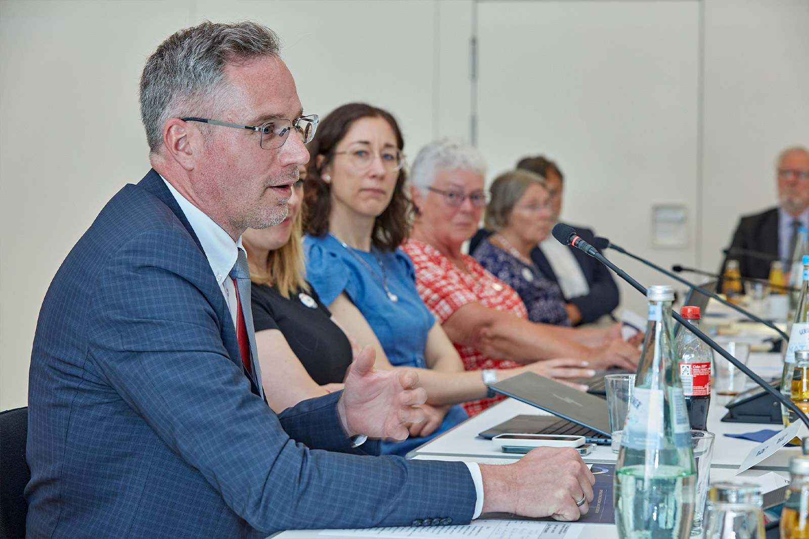 Friends of ERA members sitting at a conference table during a meeting, symbolizing dialogue, collaboration, and engagement in European law.