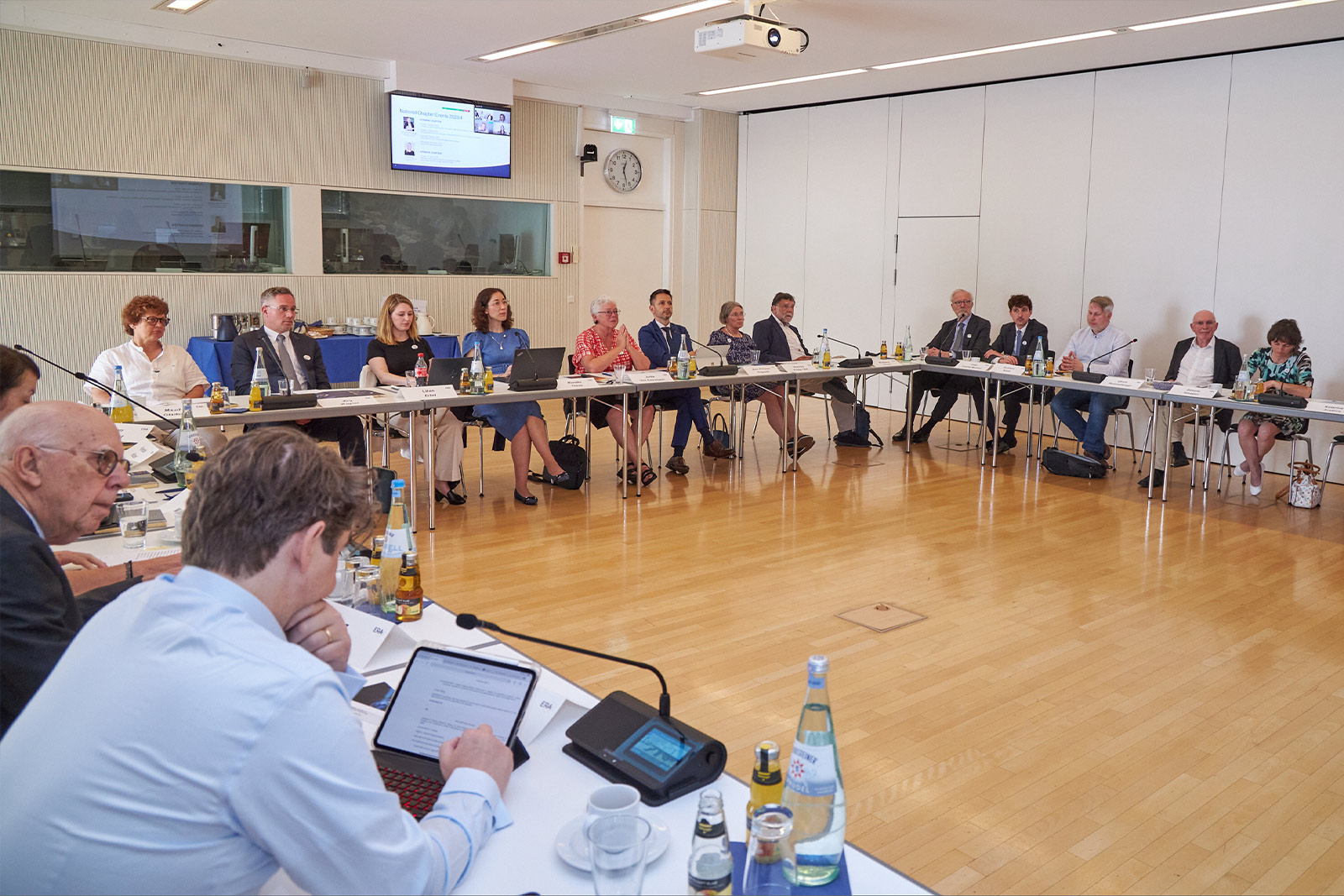 Friends of ERA members sitting at a conference table during a meeting, symbolizing dialogue, collaboration, and engagement in European law.