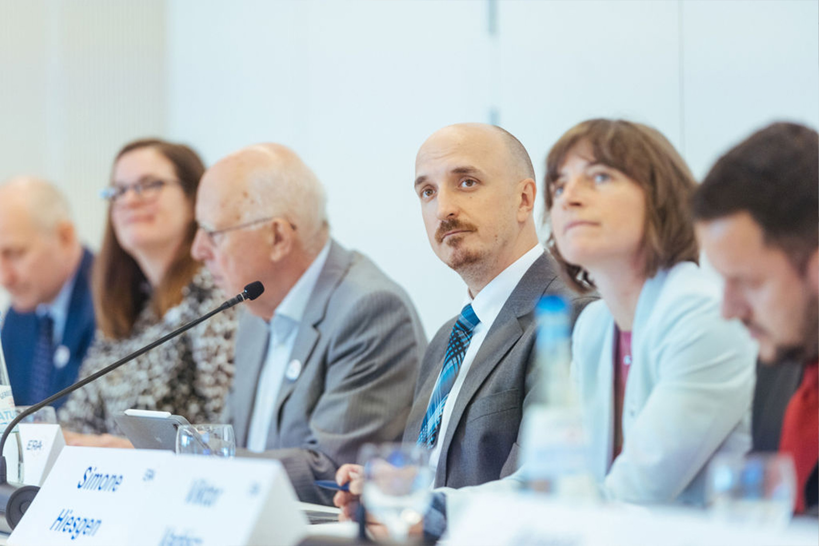 Friends of ERA members sitting at a conference table during a meeting, symbolizing dialogue, collaboration, and engagement in European law.
